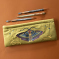 Load image into Gallery viewer, Embroidered pencil case with moth design on a brown background
