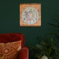 Load image into Gallery viewer, moon phase calendar 2025 uk on a green wall with a red sofa and house plant
